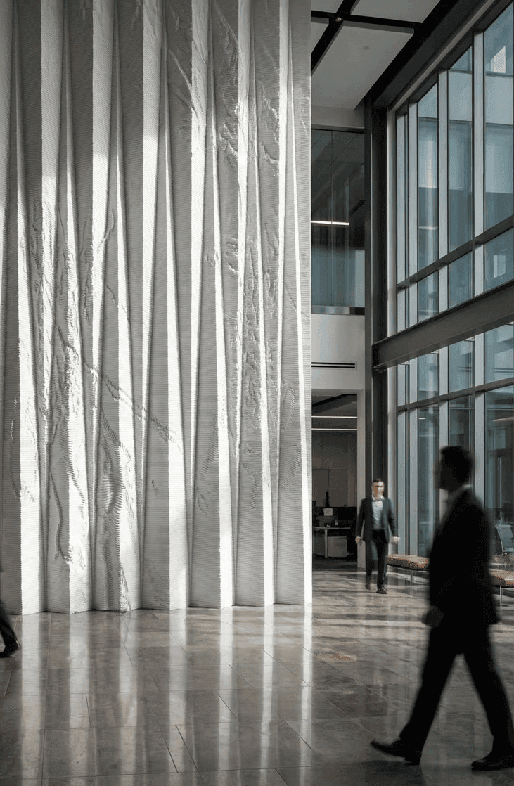 Folded Organic Lobby Wall — White Corian (SmithGroup / UF Dental)